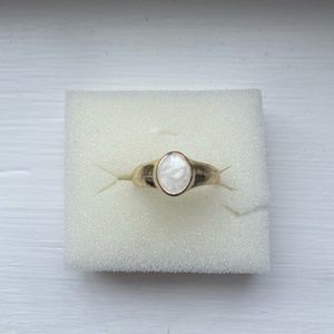 Gold coloured ring with opal stone